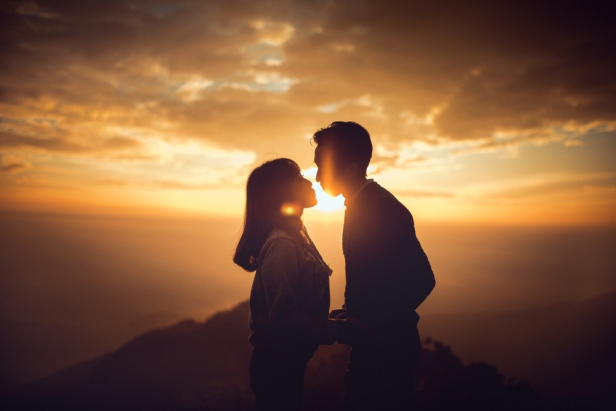 Men and women staring at the sunset in the background